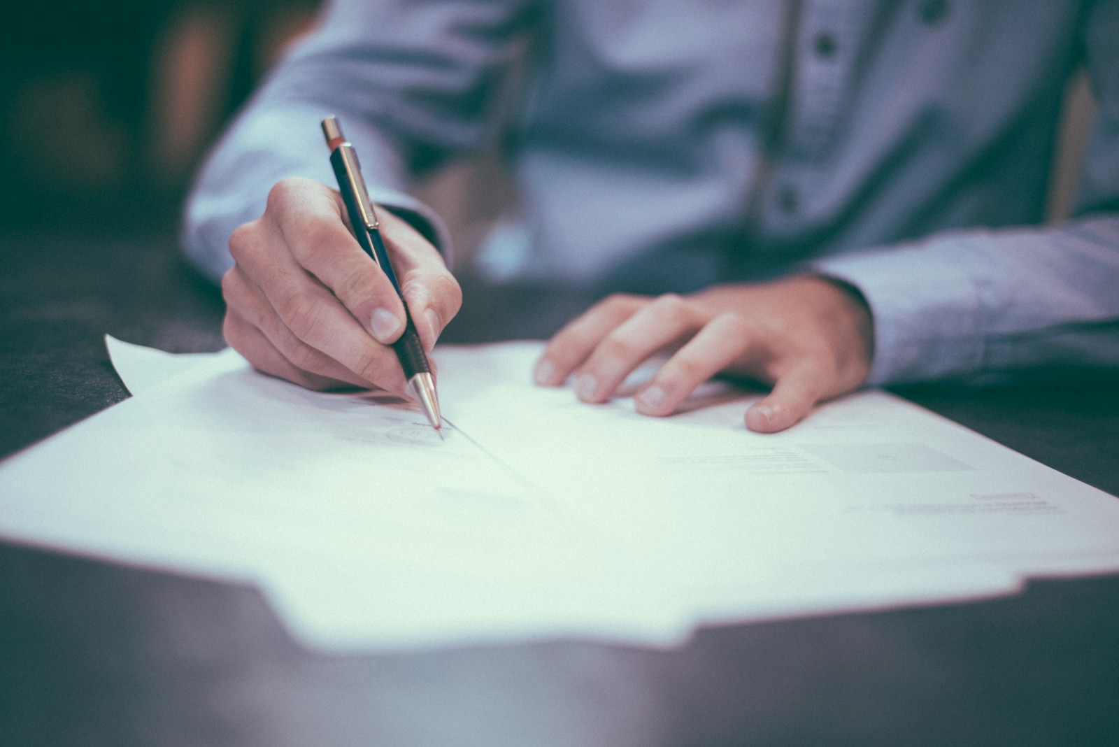 Strategist reviewing regulatory documents at a desk — AI Center of Excellence for Pharma